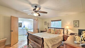 A bedroom with a bed, bedside table, lamp, and a ceiling fan. - Quincy Home w/ Deck & Outdoor Patio Furniture (Quincy)