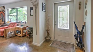 A living room with a sofa, a coffee table, and a decorative vase. - Sarasota House w/ Backyard Oasis: 6 Mi to Beach! (Sarasota)