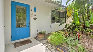 A blue door with a glass panel, a window, and a potted plant in front. - Sarasota House w/ Backyard Oasis: 6 Mi to Beach! (Sarasota)
