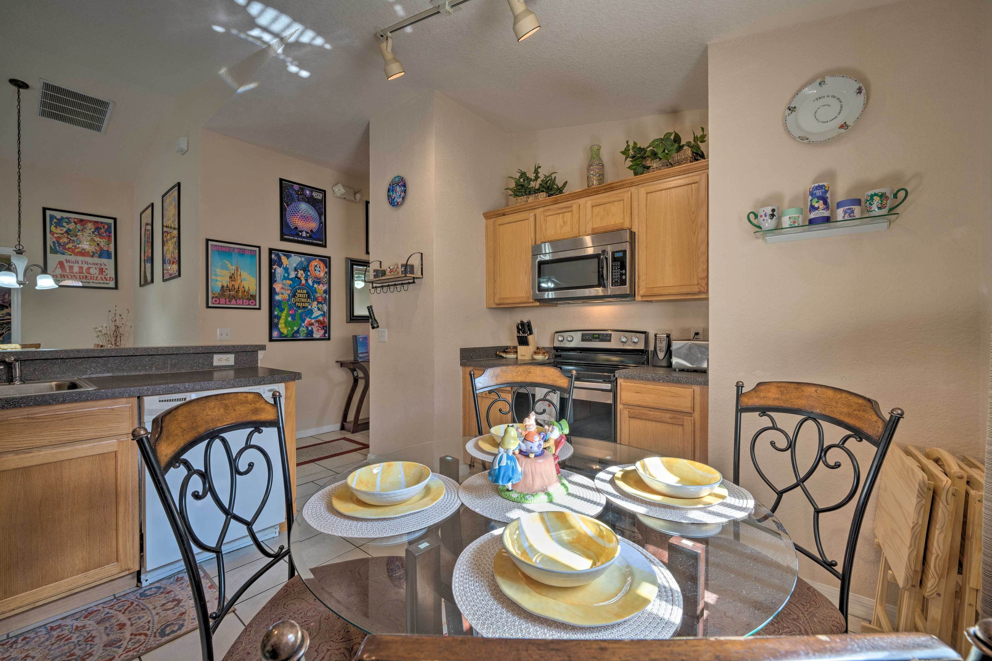A dining area with a glass table, chairs, and a decorative centerpiece.