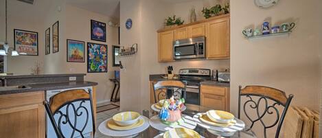 A dining area with a glass table, chairs, and a decorative centerpiece.