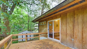 A wooden cabin with a deck, surrounded by trees. - Vacation Home Rental in Gainesville, Florida! (Gainesville)
