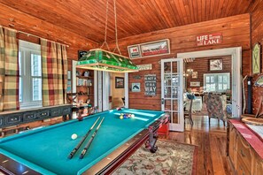 A wooden interior with a pool table, a plaid curtain, and a sign that reads "Life is better at the lake." - Lakefront Florida Retreat - Pool Table & Boat Dock (Lake Placid)