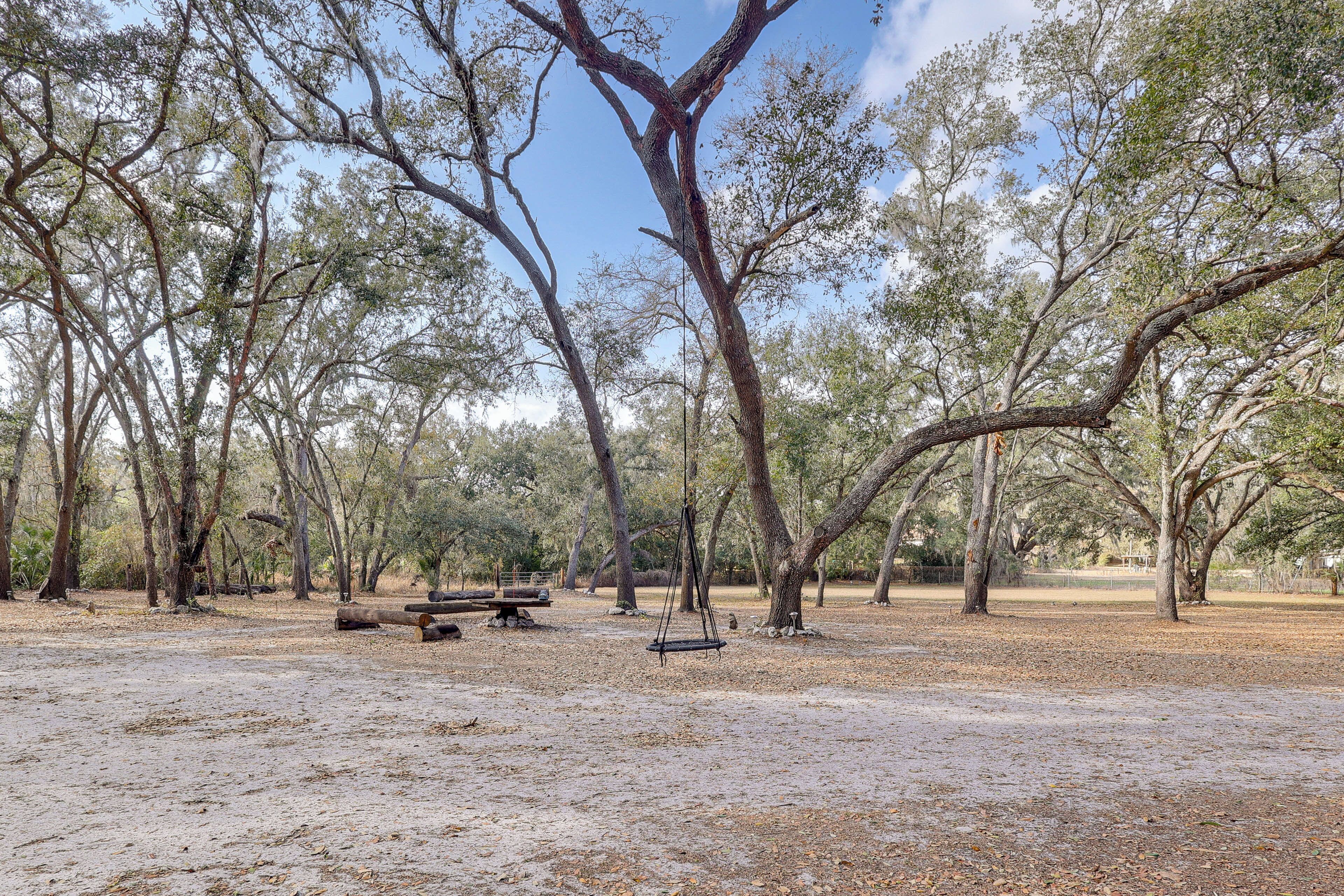 A park with picnic tables and a swing set.