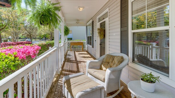 A covered porch with white wicker furniture, a potted plant, and a view of the street. - Bluffton Vacation Rental w/ Private Hot Tub (Bluffton)