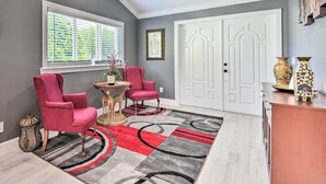A hallway with two pink chairs, a patterned rug, and a white door. - 3 Mi to Dtwn Bradenton: Home w/ Yard! (Bradenton)