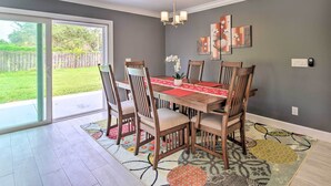 A dining area with a table, chairs, and a chandelier. - 3 Mi to Dtwn Bradenton: Home w/ Yard! (Bradenton)