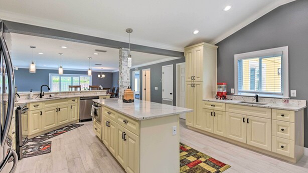 A spacious kitchen with light-colored cabinetry, a central island, and pendant lighting. - 3 Mi to Dtwn Bradenton: Home w/ Yard! (Bradenton)