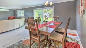 A dining area with a wooden table, chairs, and a chandelier. - 3 Mi to Dtwn Bradenton: Home w/ Yard! (Bradenton)