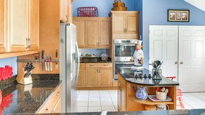A kitchen with wooden cabinets, a refrigerator, a microwave, and a stove. - 2 Mi to Beach: Hilton Head Home w/ Furnished Deck (Hilton Head Island)