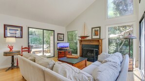 A spacious living room with a large sofa, a fireplace, and a television. - 2 Mi to Beach: Hilton Head Home w/ Furnished Deck (Hilton Head Island)