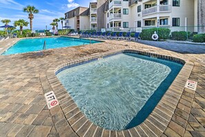 A swimming pool area with lounge chairs and a sign indicating a 1ft depth limit. - Myrtle Beach Condo w/ On-site Pool & Beach Access (Myrtle Beach)