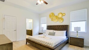 A bedroom with a large bed, a ceiling fan, a dresser, and a window with blinds. - 12 Mi to Disney: Home w/ Pool Access + Grill (Davenport)