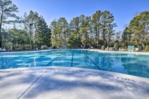 A swimming pool with clear lanes, surrounded by trees and a sign indicating no diving allowed. - 4 Mi to Ocean: Golf Resort Condo in N Myrtle Beach (North Myrtle Beach)