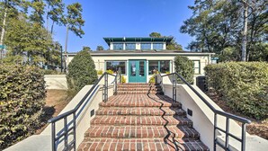 A building with a green door and a brick staircase leading to the entrance. - 4 Mi to Ocean: Golf Resort Condo in N Myrtle Beach (North Myrtle Beach)