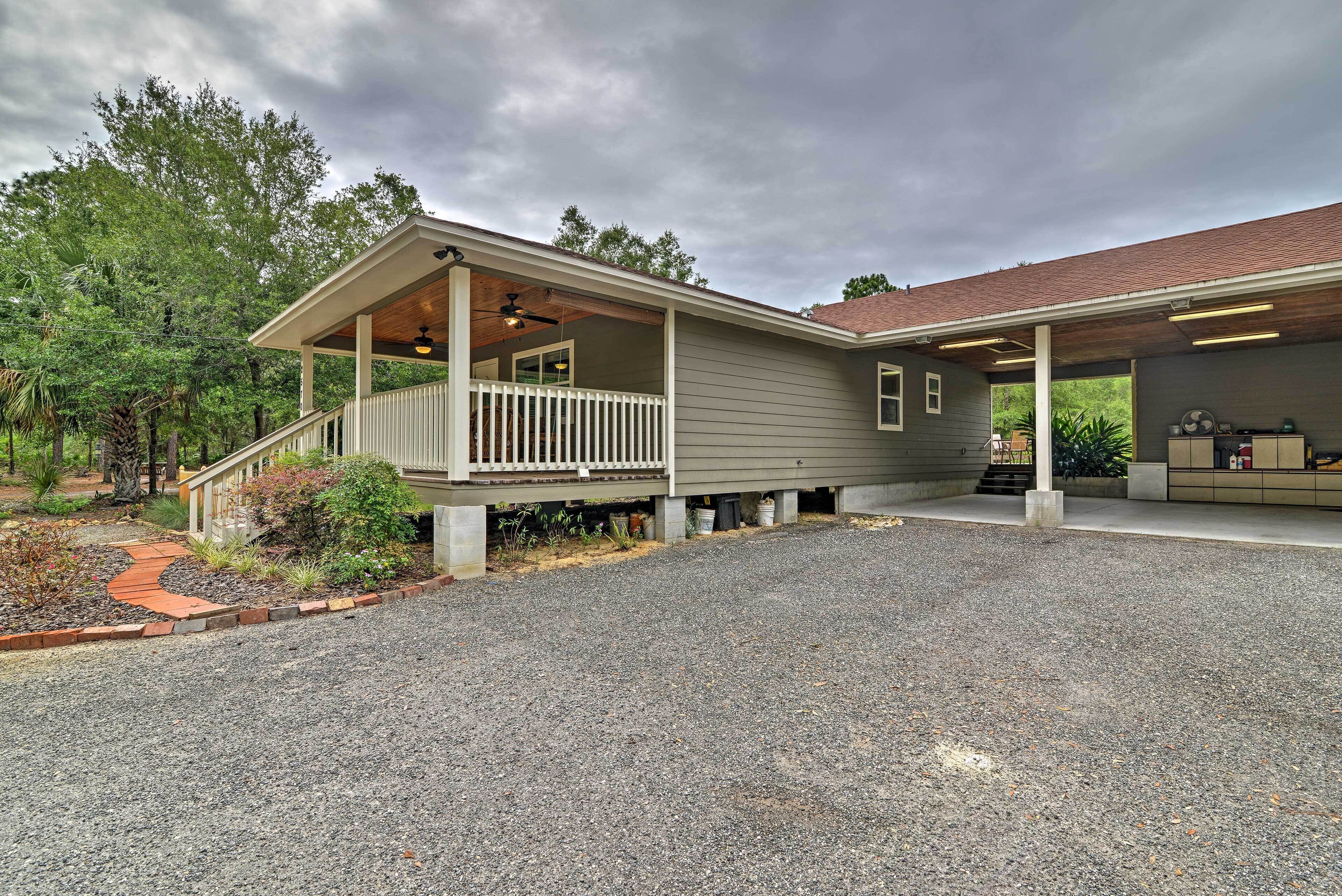A two-story house with a covered porch and a garage.
