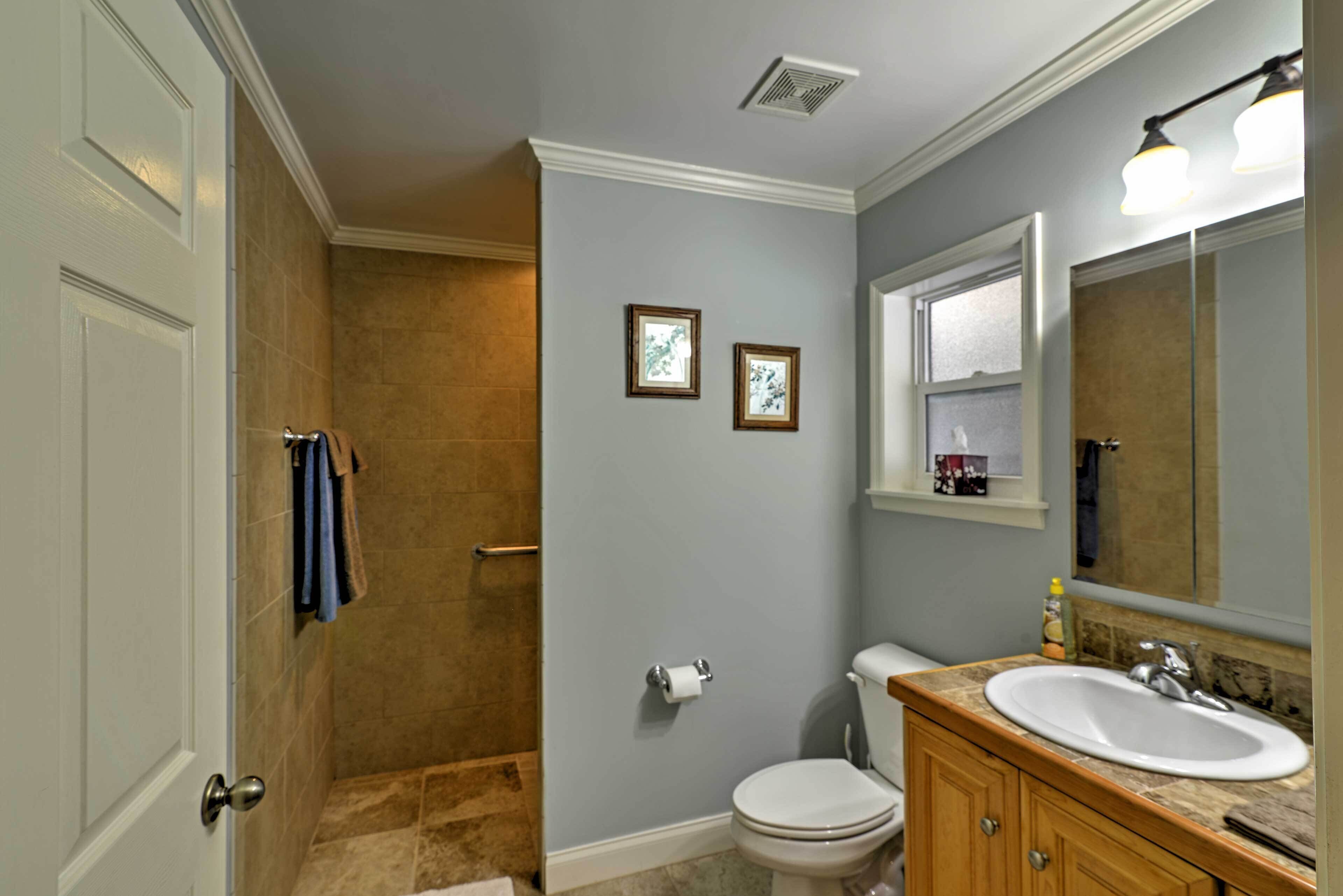 A bathroom with a toilet, sink, and shower.