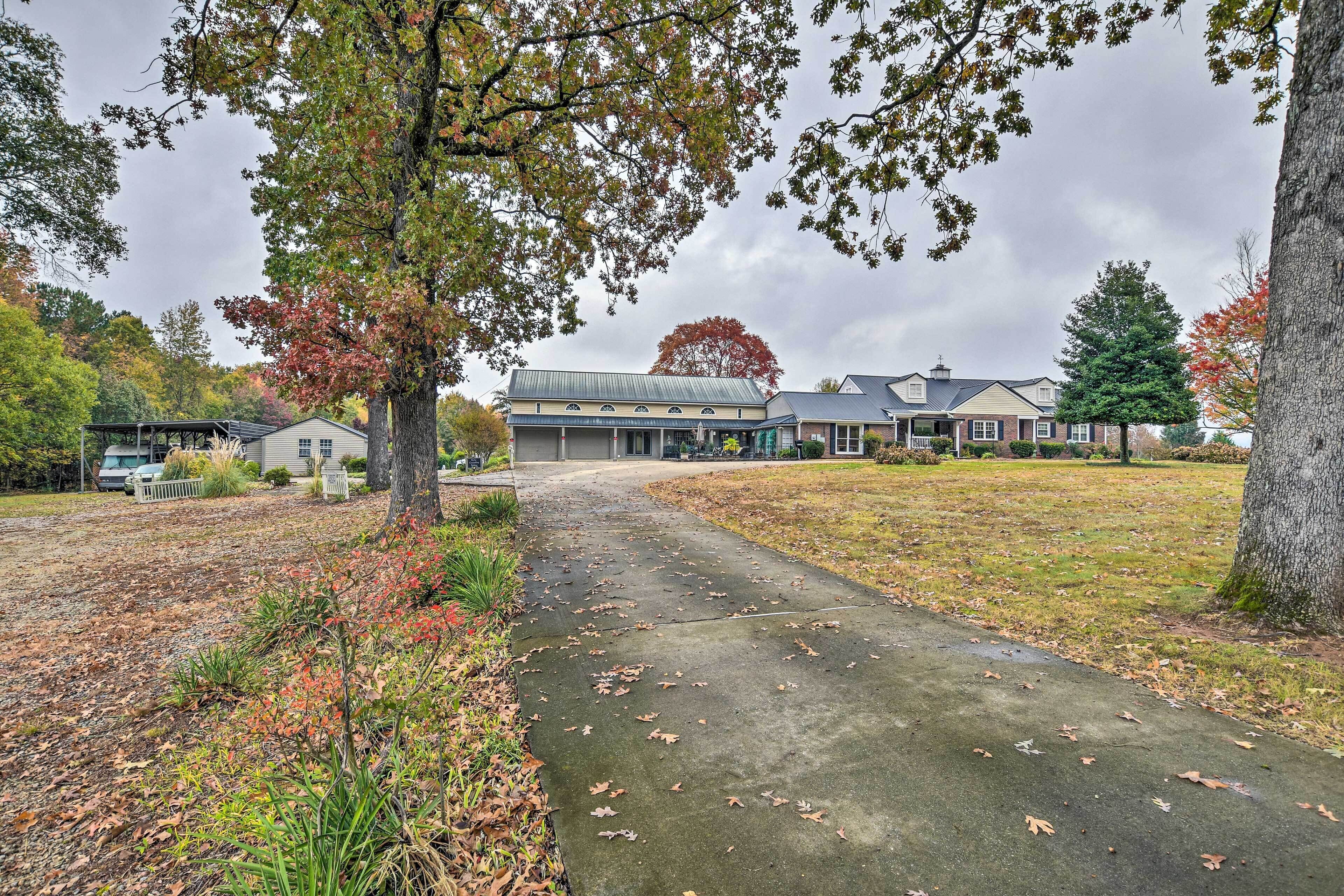 A building with a covered entrance and a driveway leading to it.