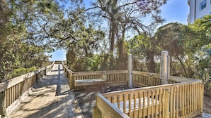 A wooden boardwalk leading to a beach area with benches and a lifeguard stand. - Half-mi to Beach: Hilton Head Condo w/ Lagoon View (Hilton Head Island)