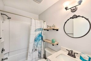 A bathroom with a shower, toilet, sink, and a mirror. - Walk to Beach: Family Hilton Head Island Condo (Hilton Head Island)