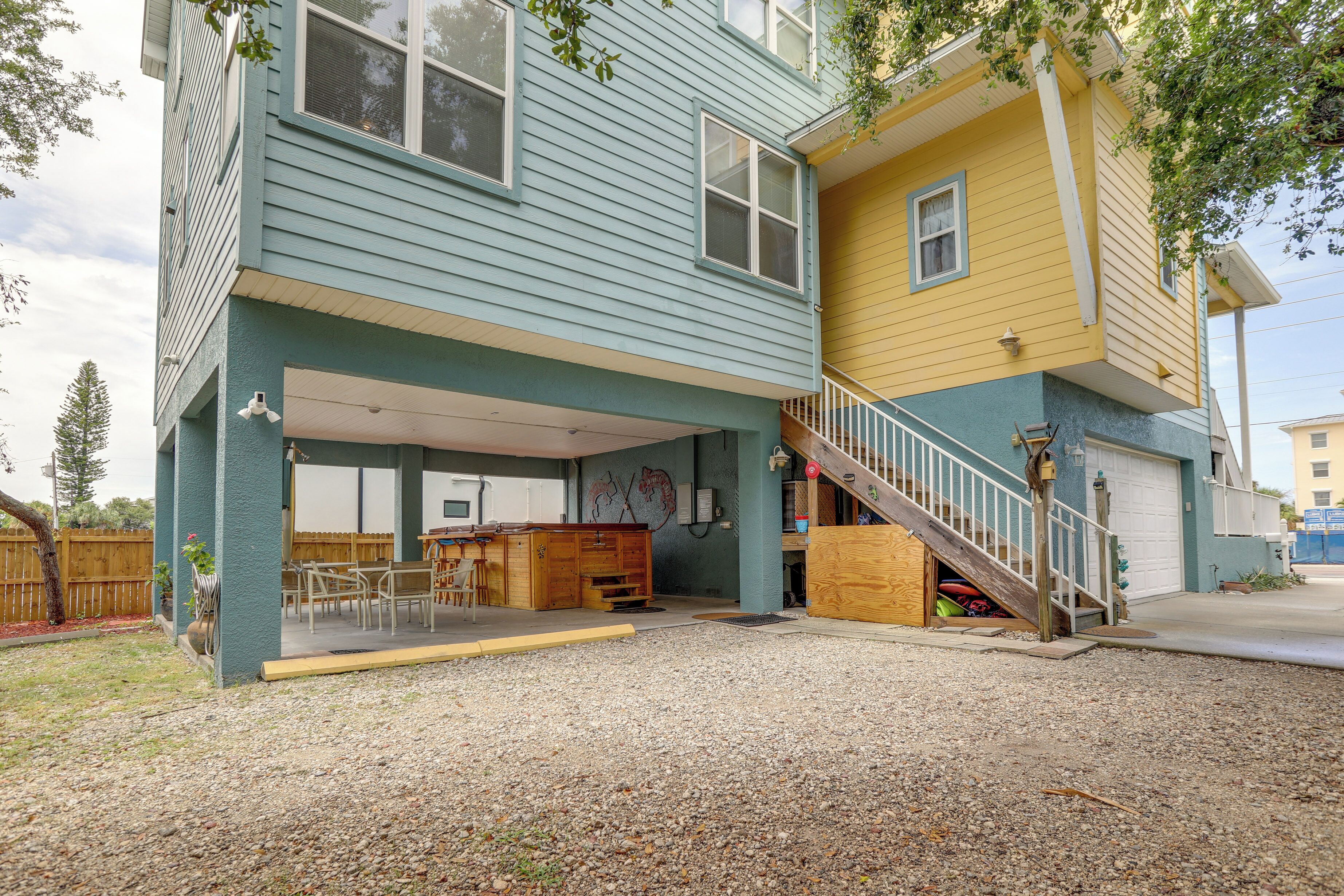 A two-story house with a covered patio and a wooden deck.