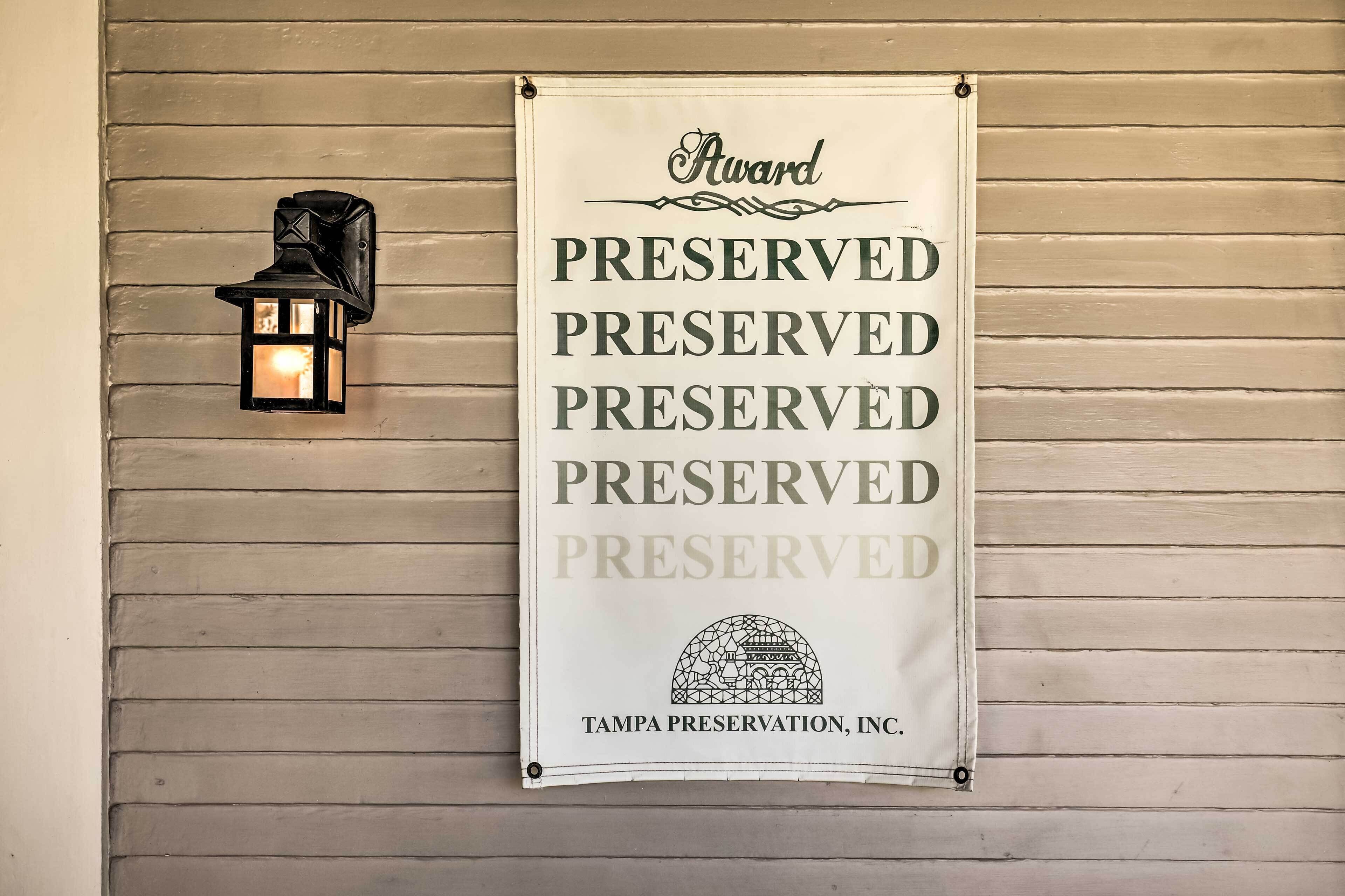A banner on a wall with the text "Award PRESERVED PRESERVED PRESERVED PRESERVED PRESERVED" and "TAMPA PRESERVATION, INC."