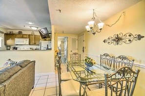 Enjoy a spacious living area with a kitchen, dining table, and comfortable sofa.