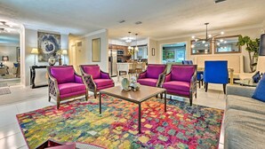 A spacious living room with a colorful rug, purple armchairs, and a coffee table. - Huge Lutz Family Retreat w/ Game Room & Pool! (Lutz)