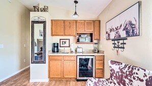 A compact kitchen with wooden cabinets, a refrigerator, a microwave, and a toaster. - Lady Lake Studio - 7 Mi Lake Griffin State Park! (Lady Lake)