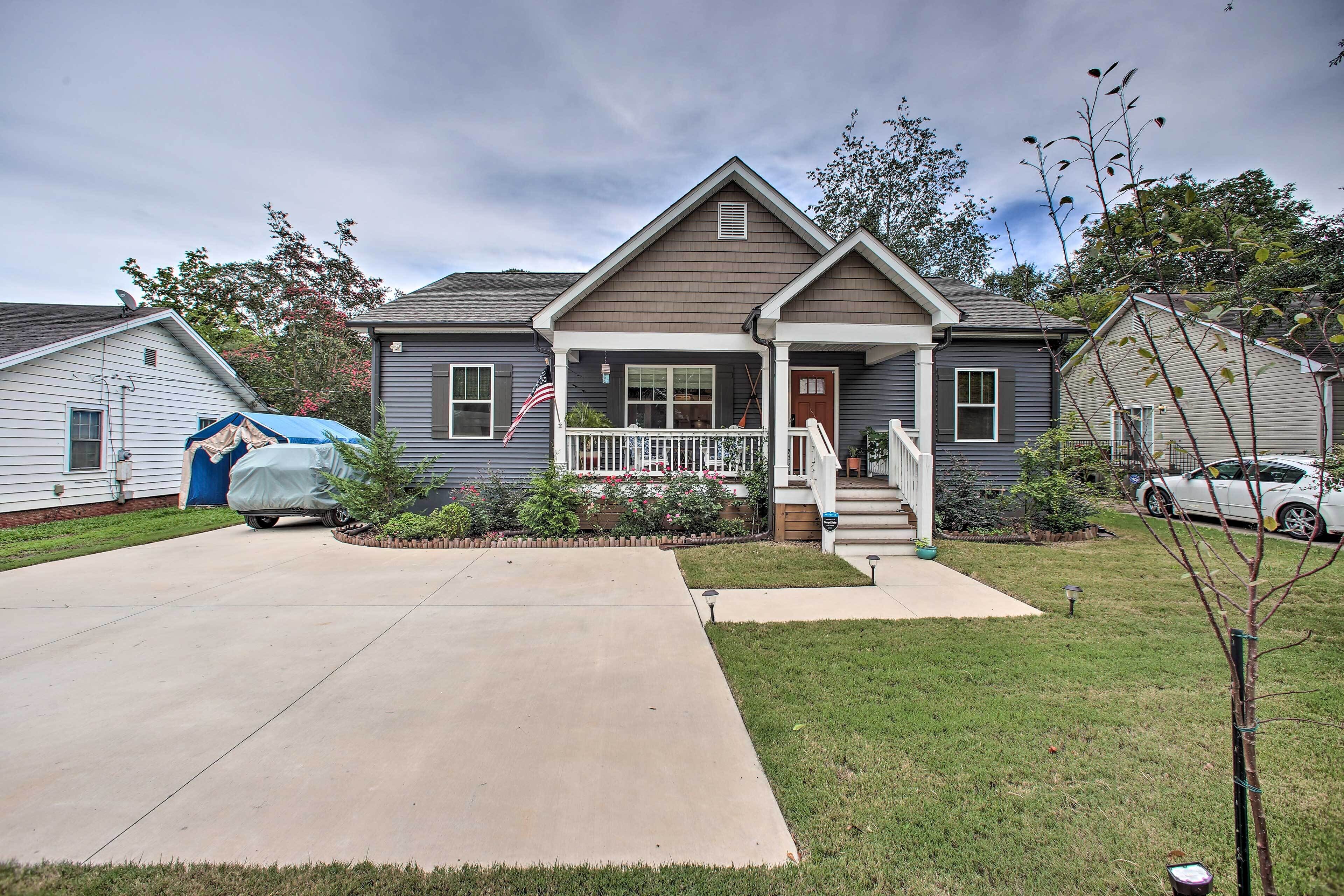 A residential house with a front porch, a driveway, and a lawn.