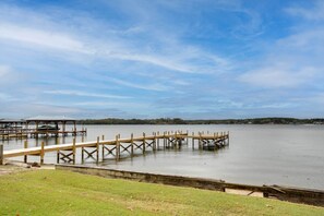 A calm lake with wooden docks extending into the water. - Lakefront House w/ Boat Ramp, Dock & Sunset Views! (Cross Hill)