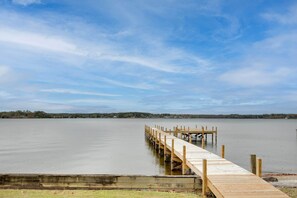 A wooden dock extending into calm water with a clear sky above. - Lakefront House w/ Boat Ramp, Dock & Sunset Views! (Cross Hill)