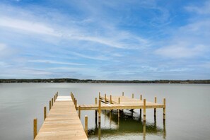 A wooden pier extending into calm water with a clear sky above. - Lakefront House w/ Boat Ramp, Dock & Sunset Views! (Cross Hill)