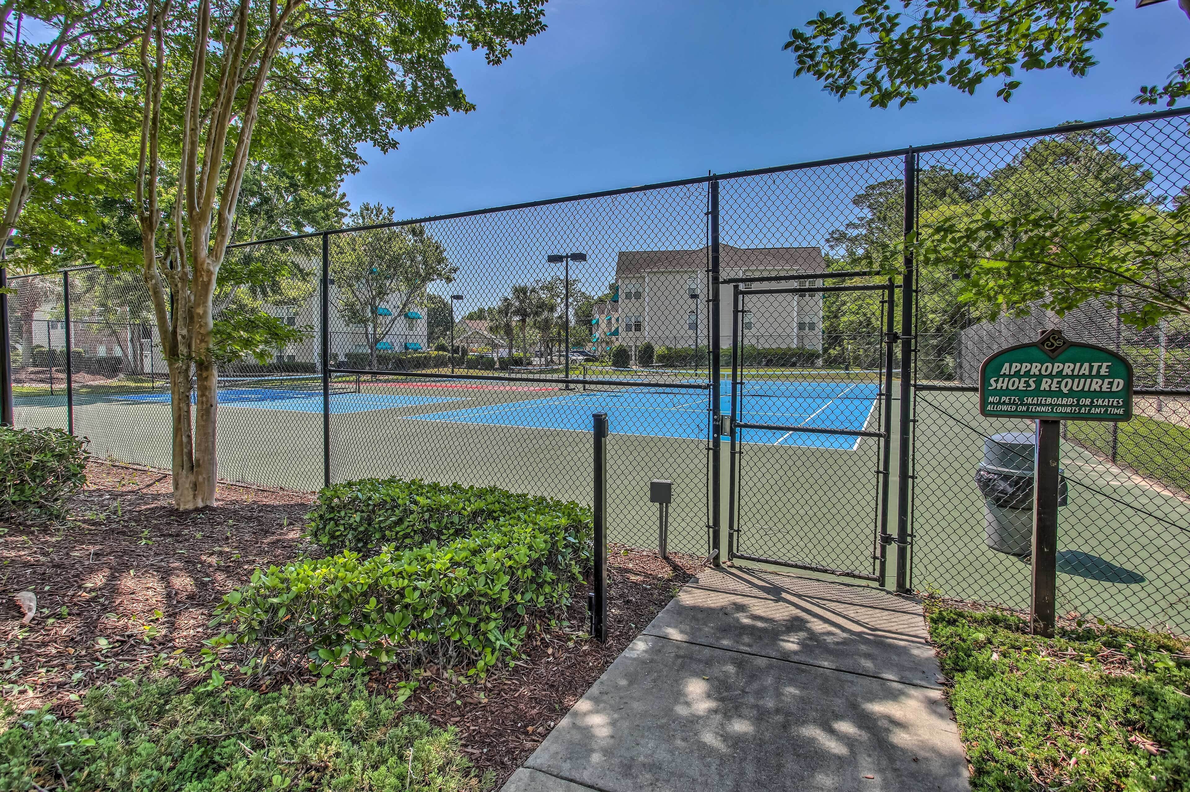 A fenced tennis court with a sign stating "Appropriate shoes required."