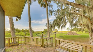 Relax on the deck overlooking the well-maintained lawn and golf course beyond.