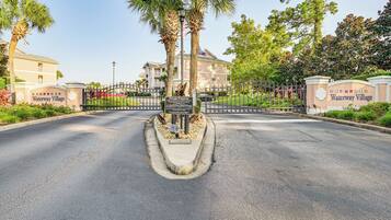 A gated entrance to Waterway Village with a sign indicating it is private property.