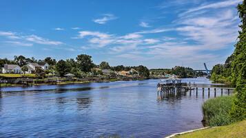 A calm river with wooden docks and houses along the banks.