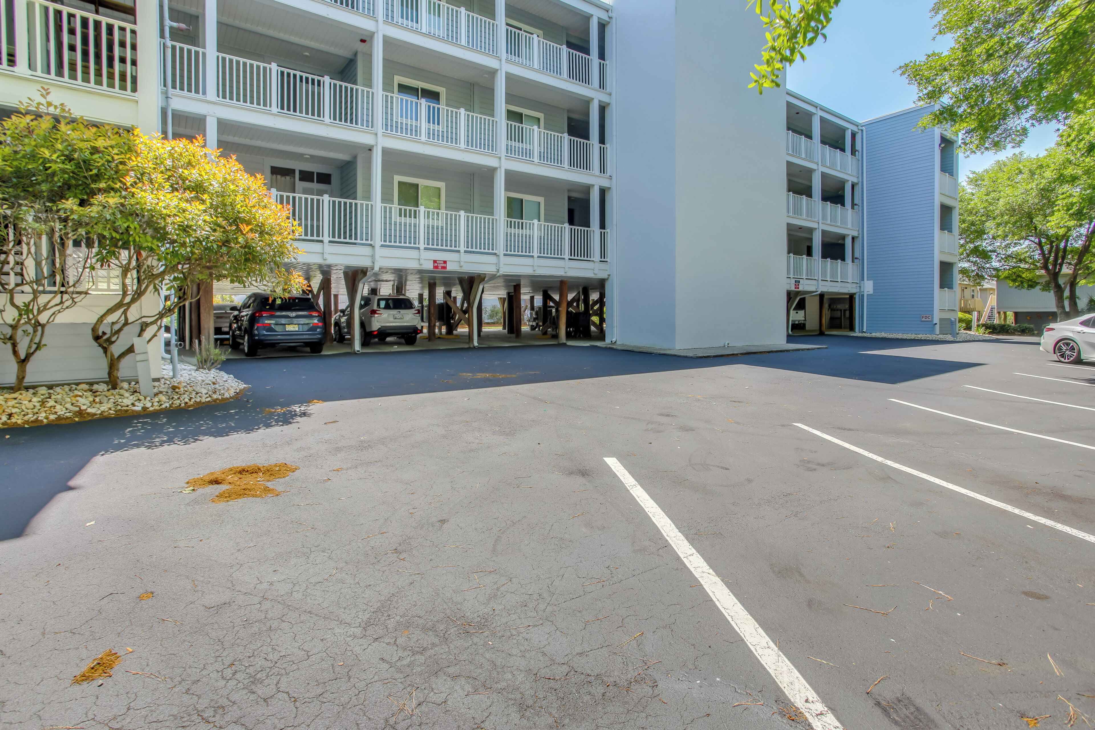 A multi-story parking garage with a white exterior and balconies.