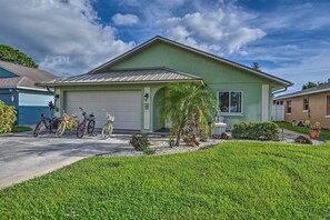 A single-story house with a garage, a driveway, and a well-maintained lawn. - Naples Paradise w/ Grill, 1 Mi to Vanderbilt Beach (Naples)