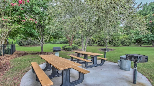 A picnic area with wooden benches and a mailbox.