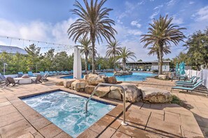 A pool area with multiple pools, lounge chairs, and palm trees. - Santa Rosa Beach Retreat w/ Endless Amenities (Santa Rosa Beach)