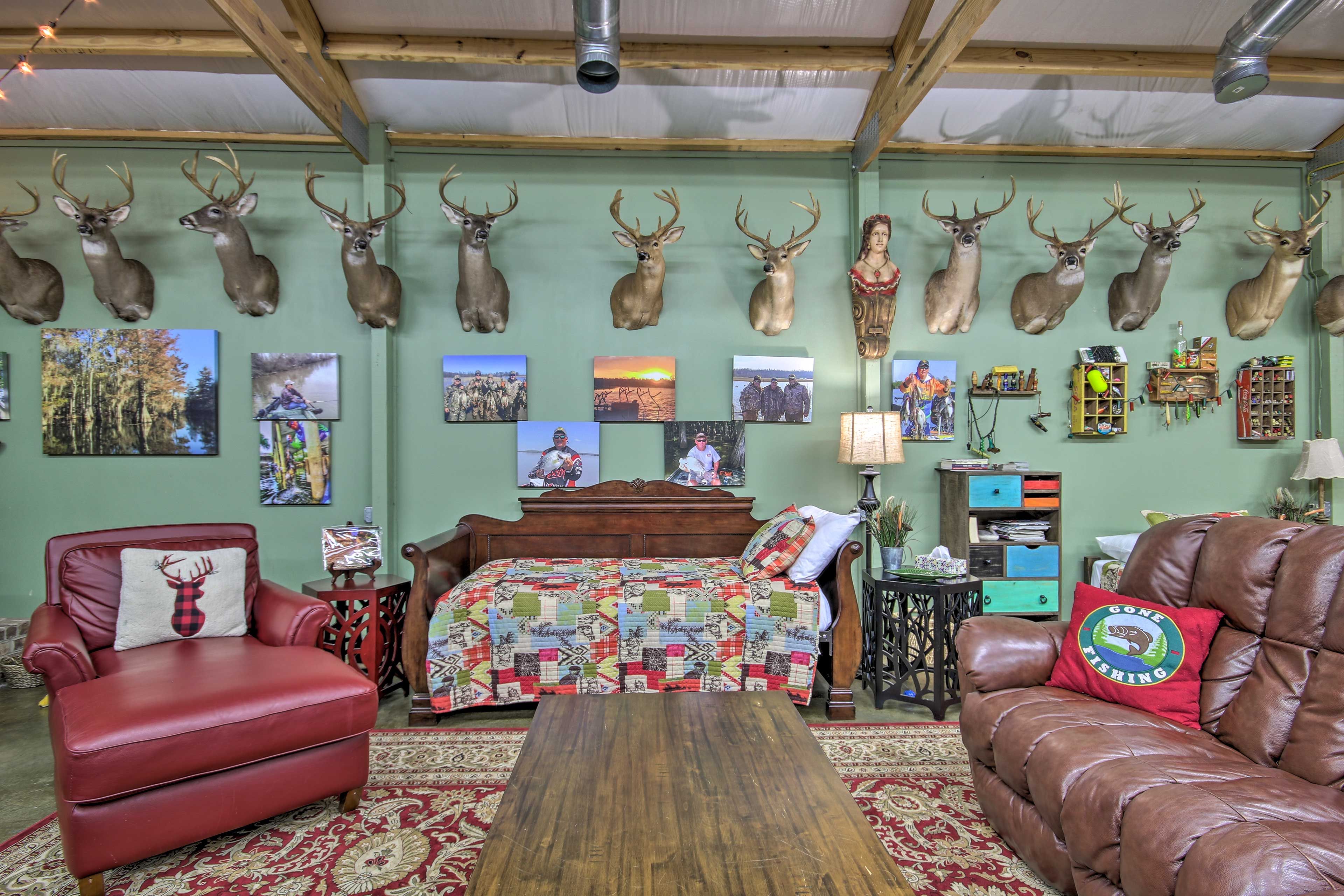 A cozy living room with a red leather armchair, a brown leather sofa, and a wooden coffee table.
