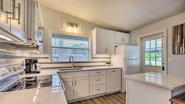 A modern kitchen with white cabinetry, a stainless steel range, and a built-in oven. - 'sarasota Sunset House' w/ Spacious Patio! (Sarasota)