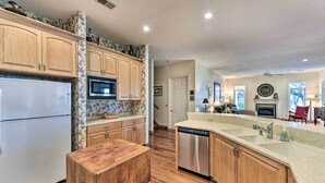 A kitchen with wooden cabinets, a white refrigerator, a dishwasher, and a microwave. - Waterfront Home w/ Shared Dock on Okatie River (Bluffton)