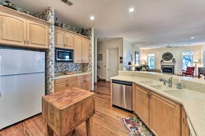 A kitchen with wooden cabinets, a white refrigerator, a dishwasher, and a microwave. - Waterfront Home w/ Shared Dock on Okatie River (Bluffton)