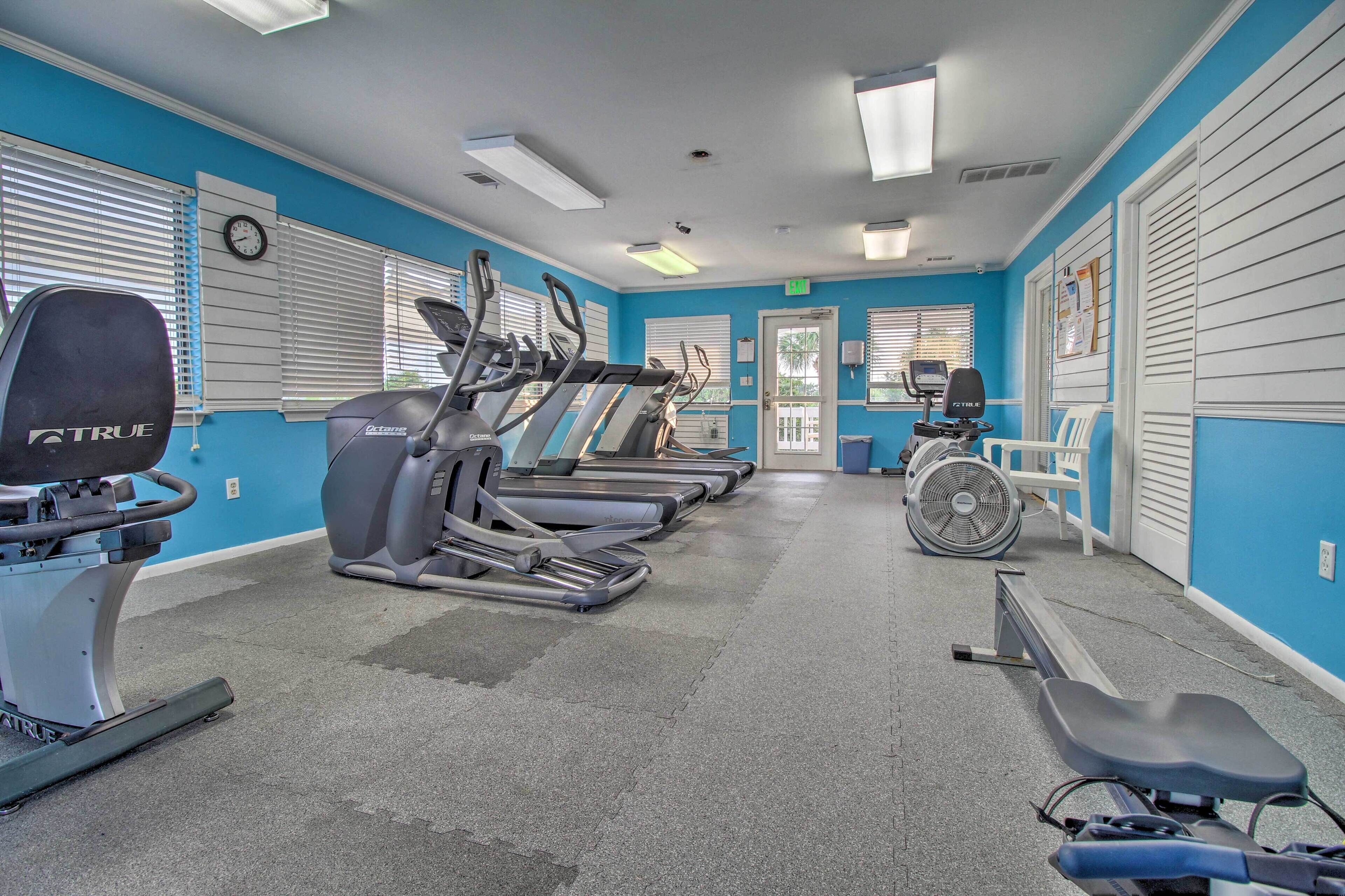 A gym with treadmills, a stationary bike, and a rowing machine.
