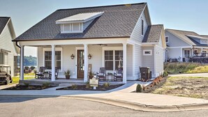 A single-story house with a covered porch, a small garden, and a sign indicating it is a rental property.
