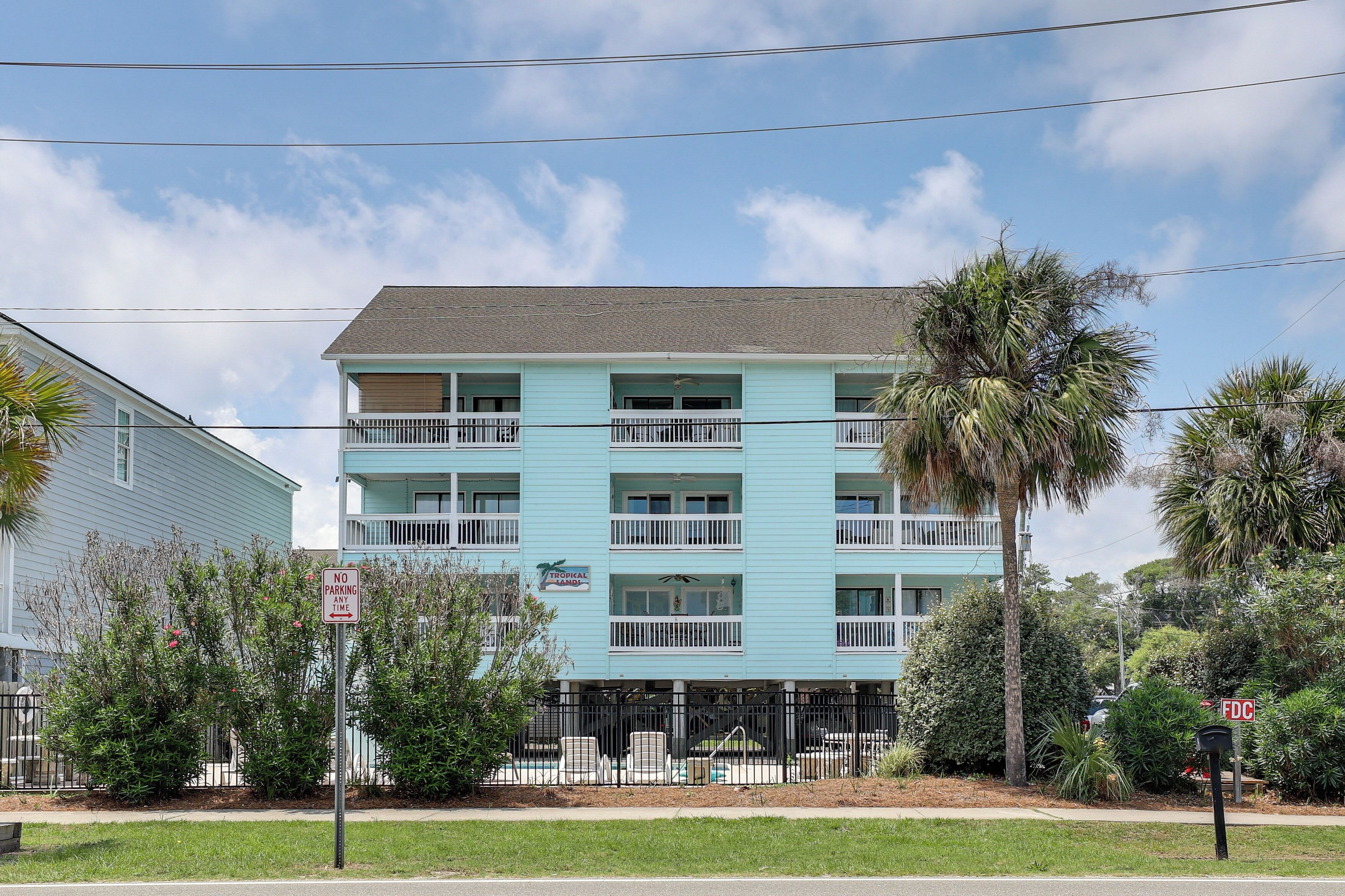 A multi-story building with balconies, a no parking sign, and a sign for 'The Medical Center.'