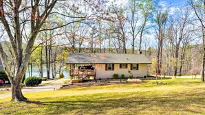 A single-story house with a front deck and a garage. - Townville Lake House w/ Private Dock, Kayaks! (Townville)