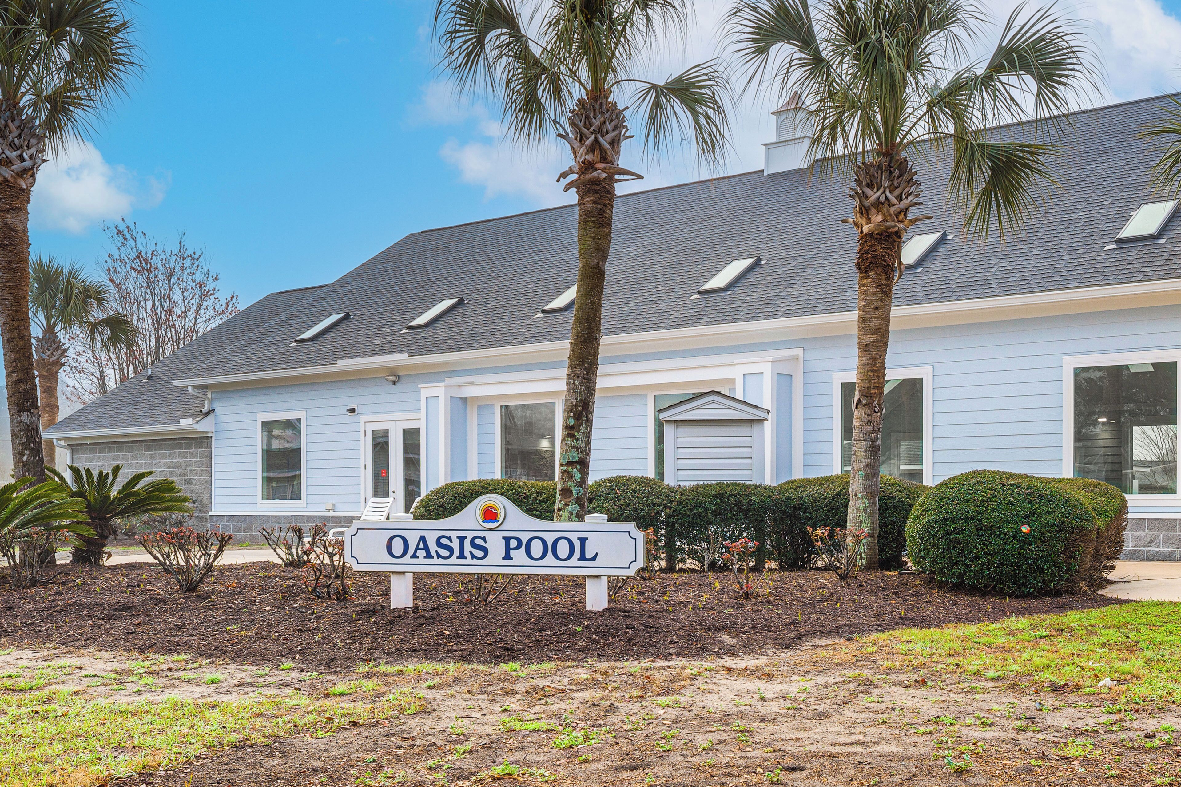 A two-story building with a sign reading 'OASIS POOL'.